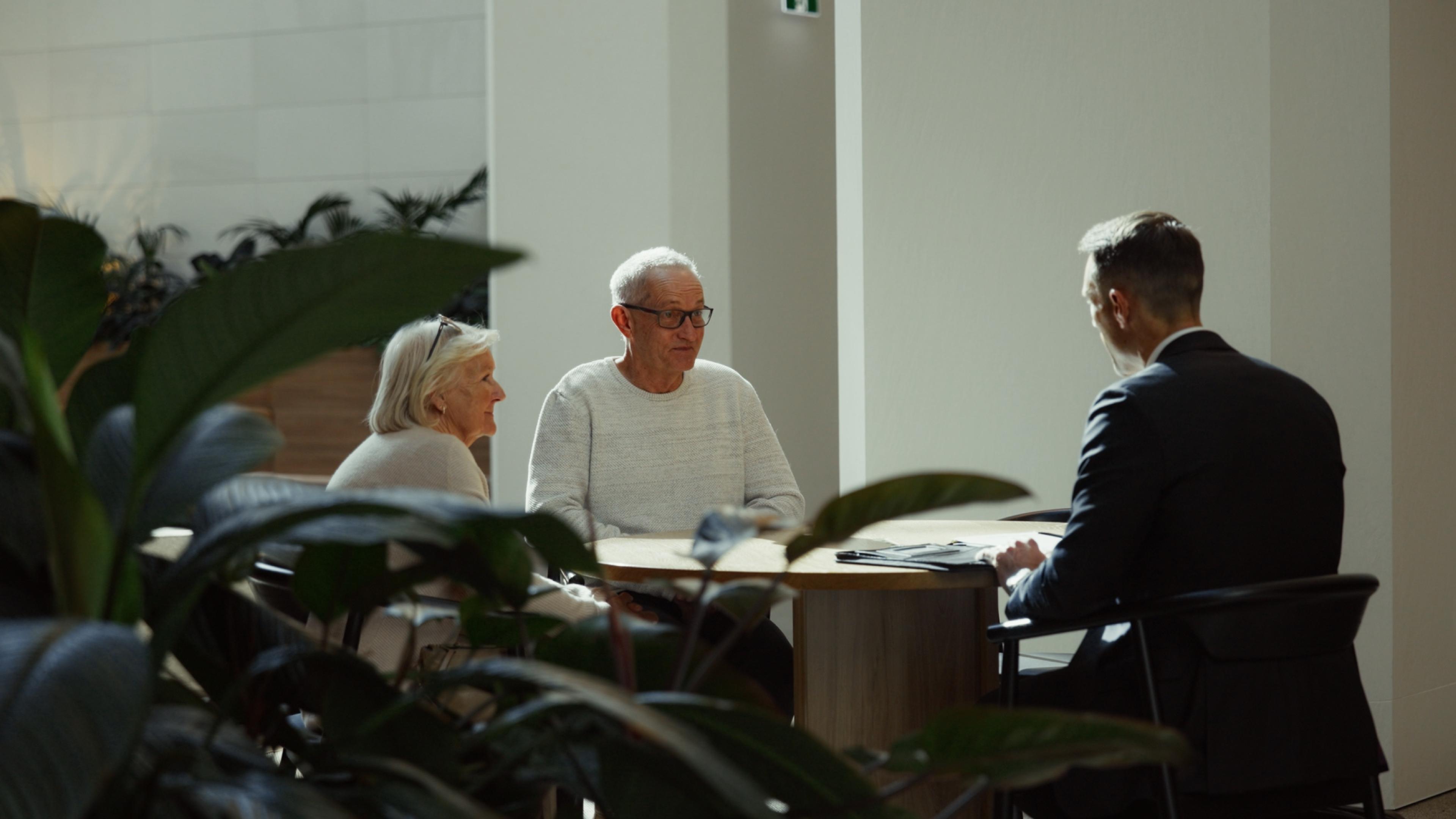 A meeting with older clients among the plants
