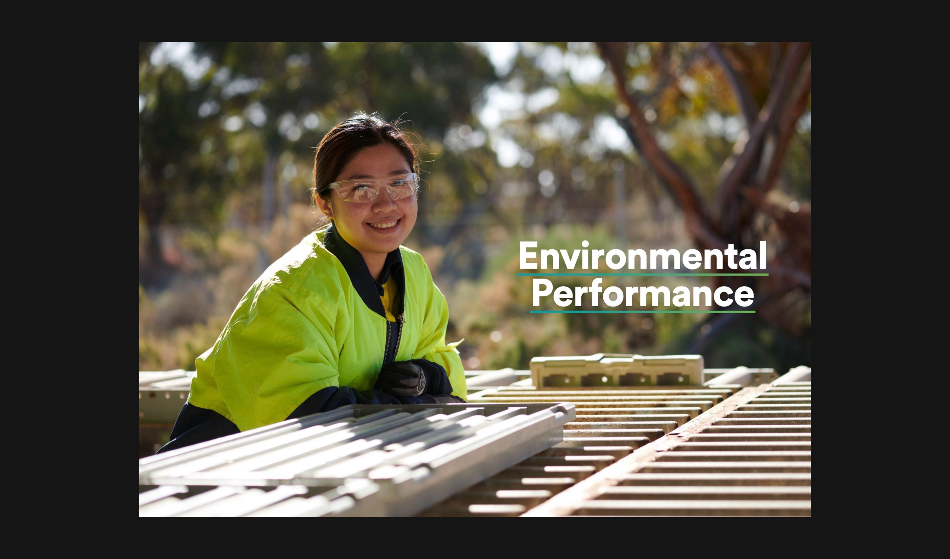 Smiling worker in hi-vis leaning on core trays