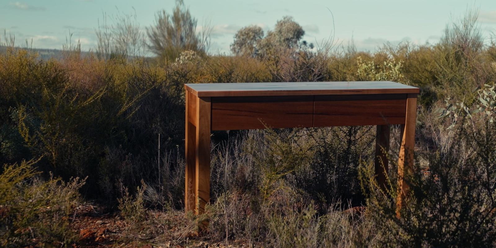 Watermans hall table standing in low bush