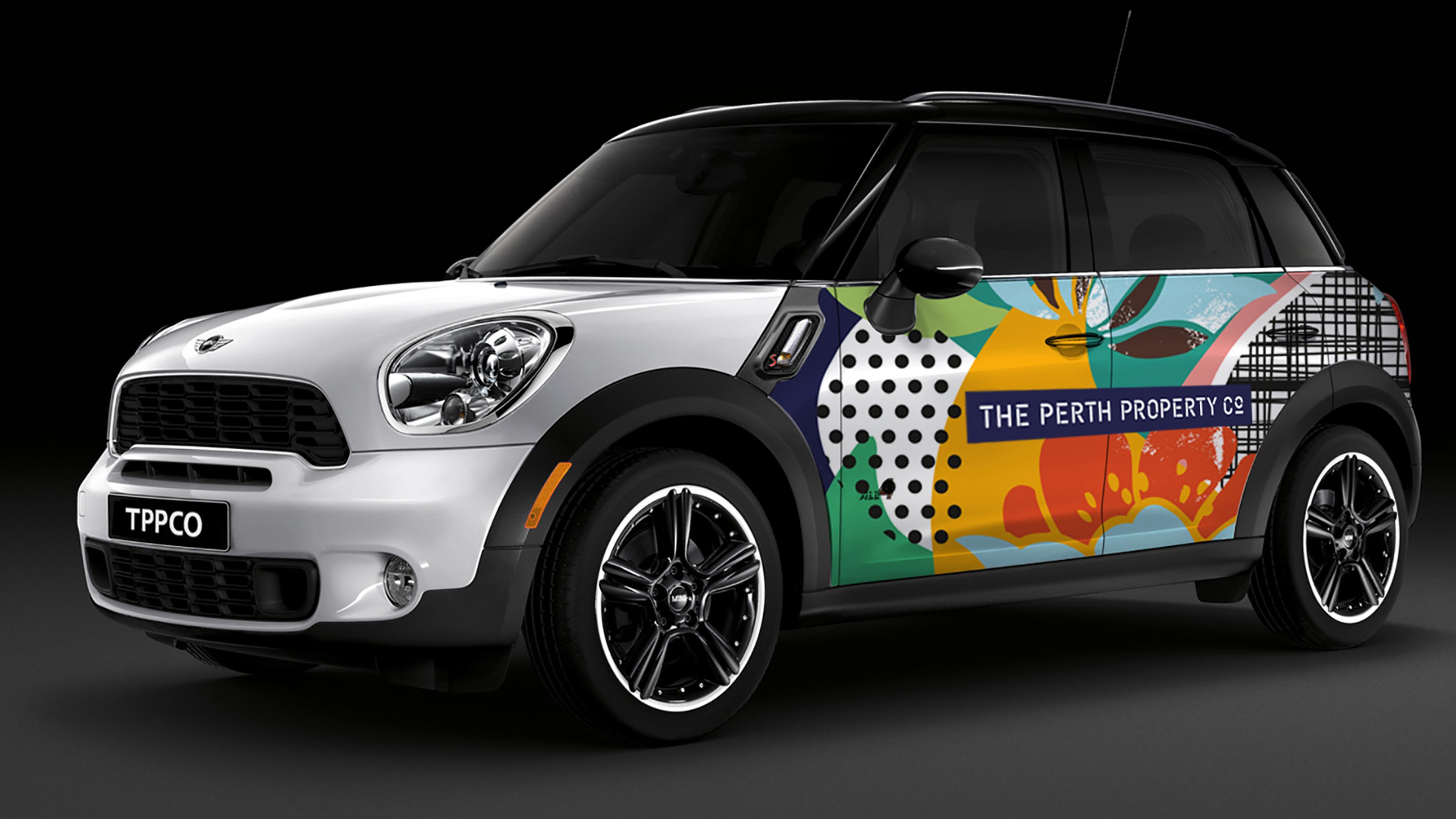 The Perth Property Co Mini Countryman from the side, wrapped in the botanical pattern with the wordmark on the doors