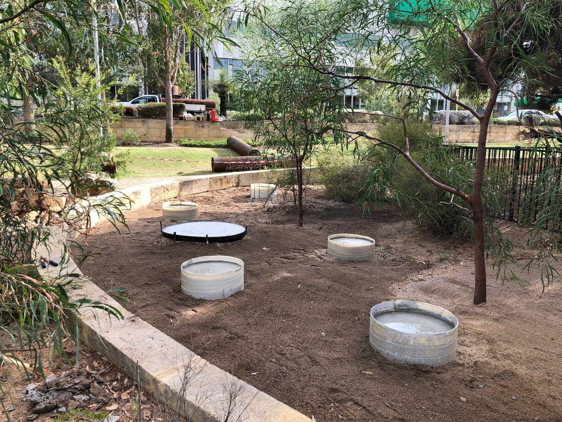 Round concrete footings in the prepared garden bed
