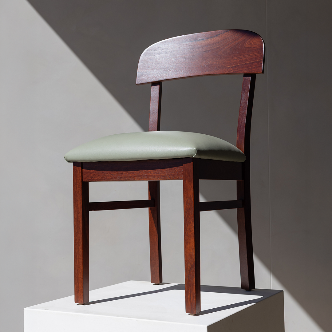 Carousel ad card: the Dongara dining chair in hard afternoon light