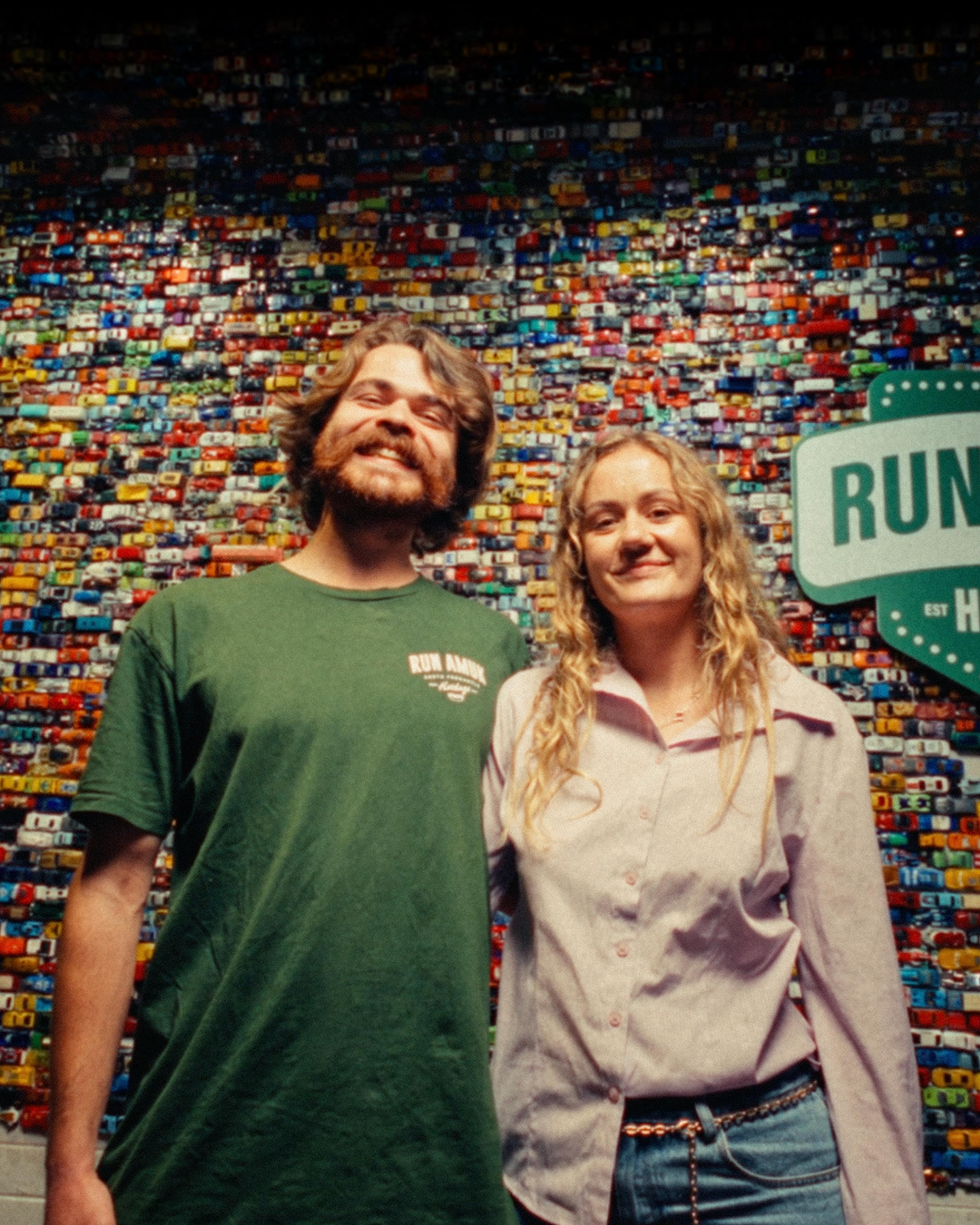 Run Amuk Hotdogs staff in front of the shop’s toy-car wall