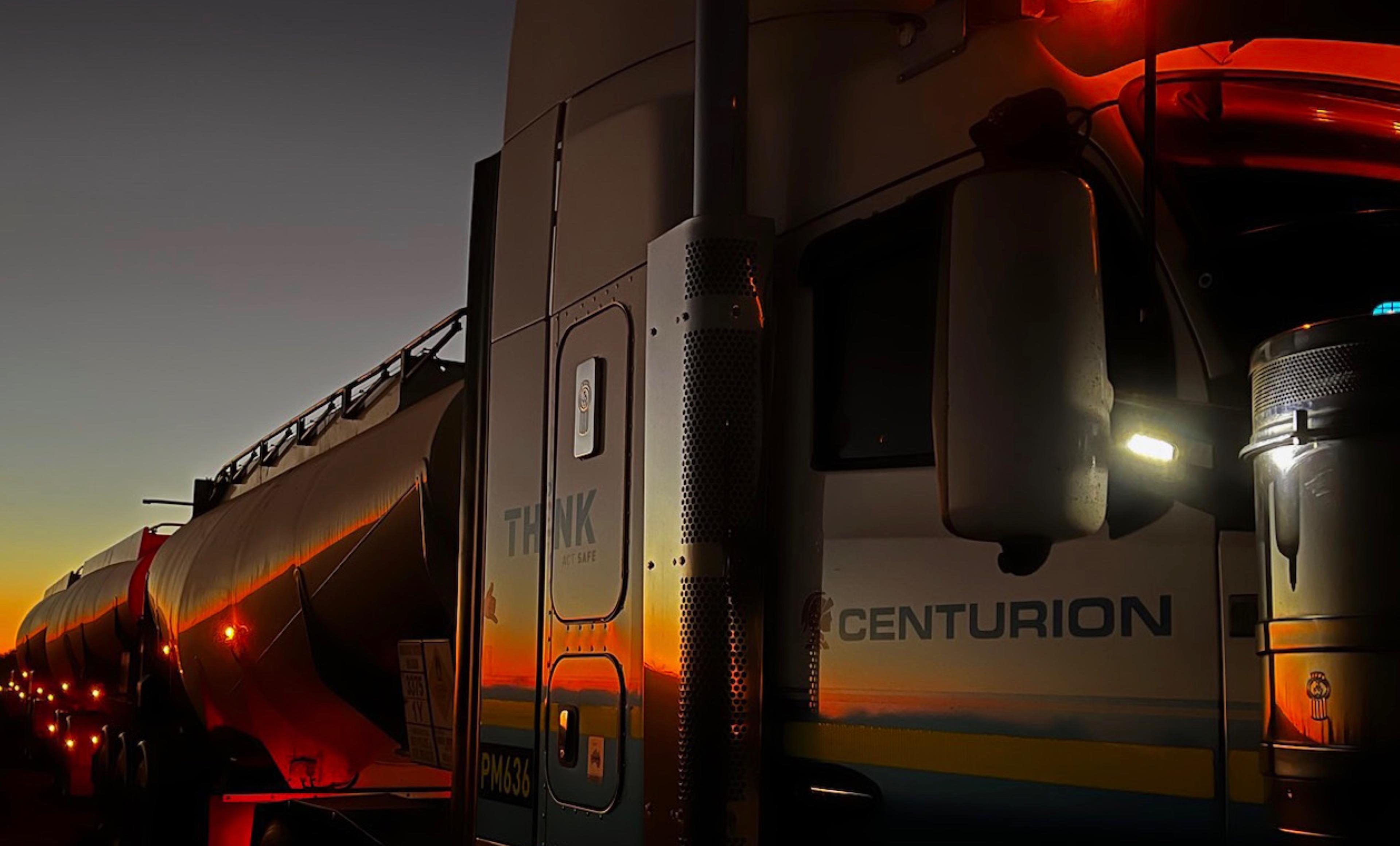 A Centurion road train at dusk in the Tanami, its tankers catching the last orange light, by CFC employee Paul Whitfield
