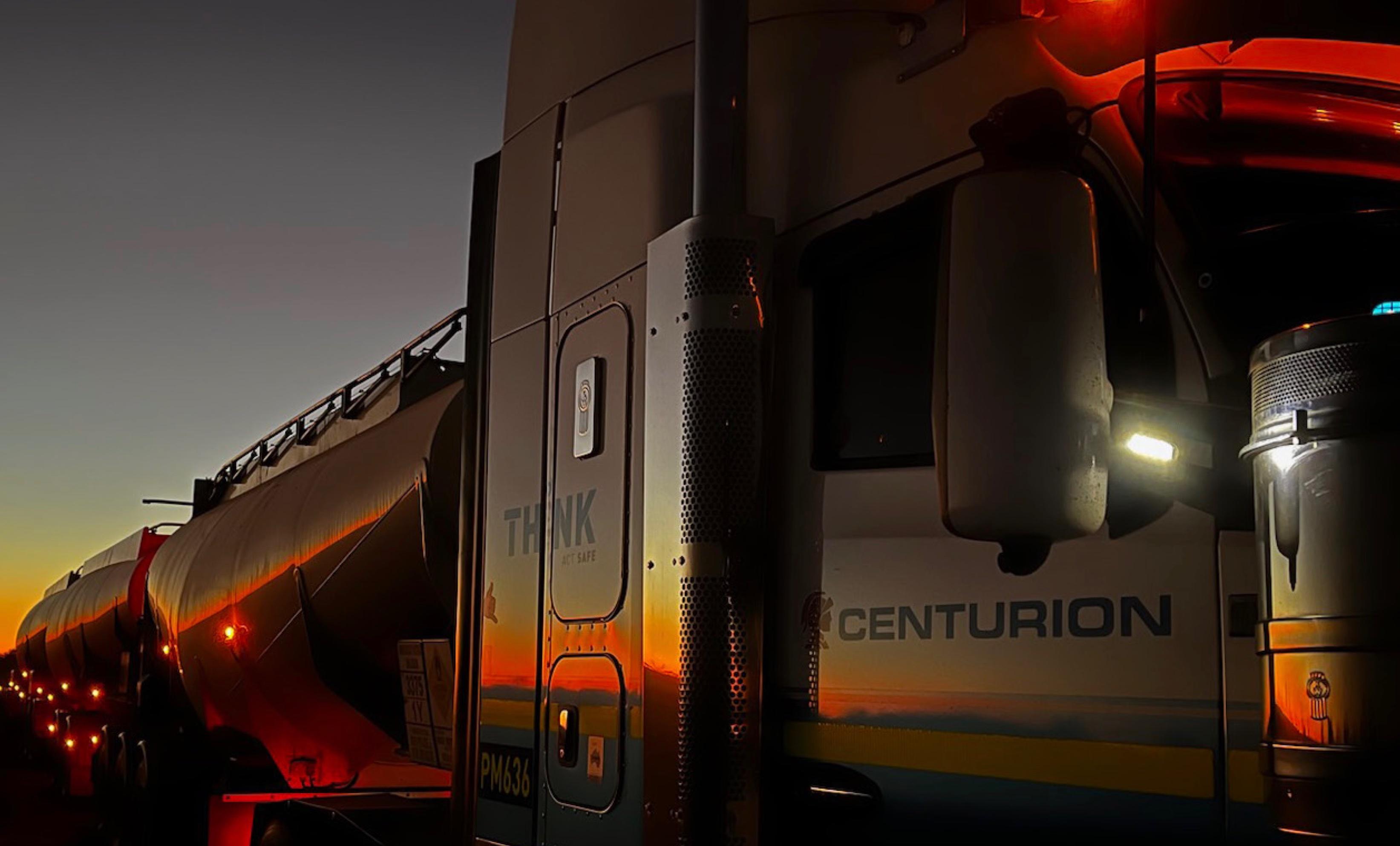 A Centurion road train at dusk in the Tanami, its tankers catching the last orange light, by CFC employee Paul Whitfield