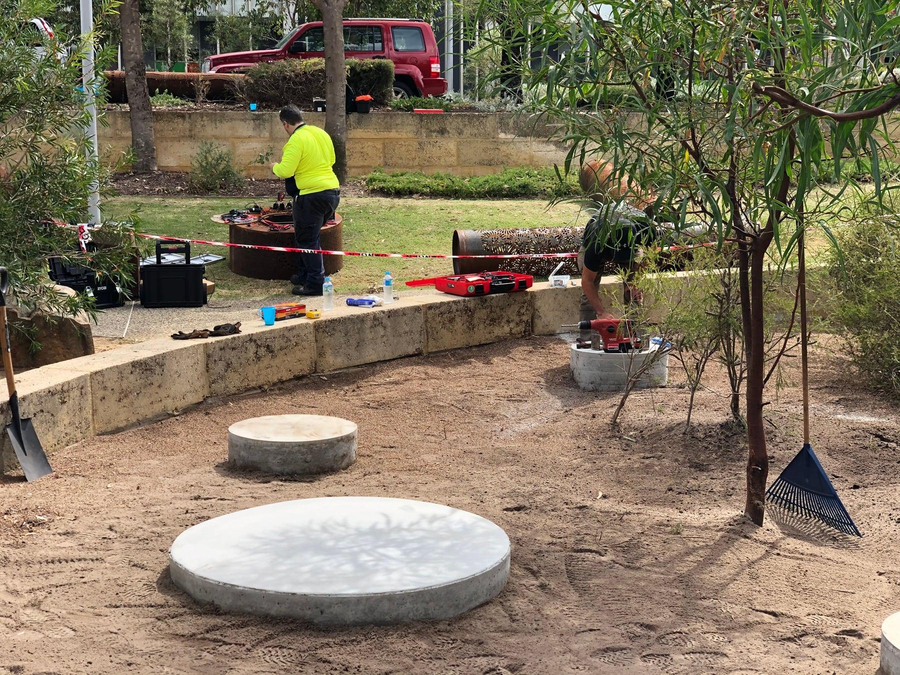 Installers working around the concrete footings
