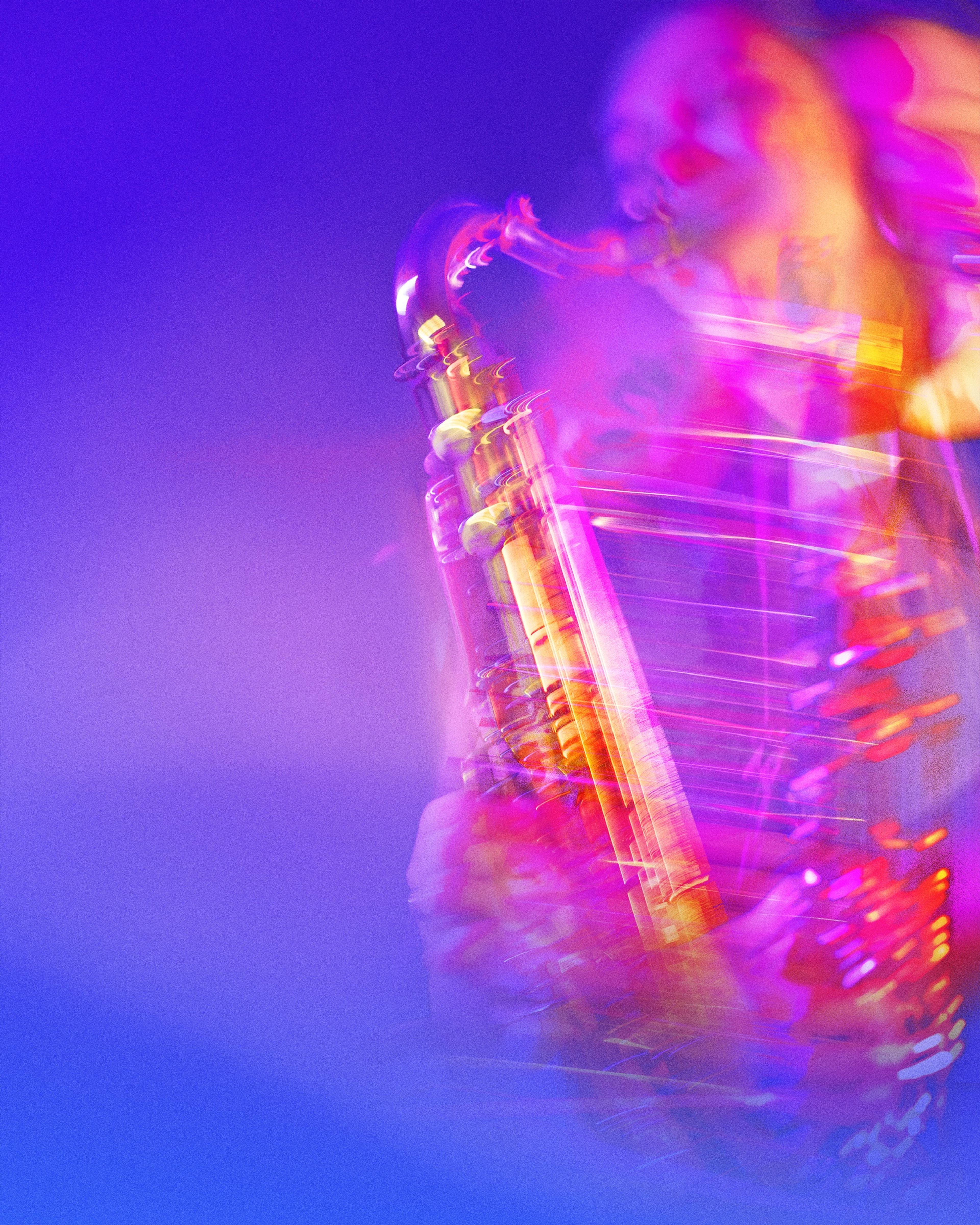 A saxophonist mid-solo in blue and pink light, blurred with movement