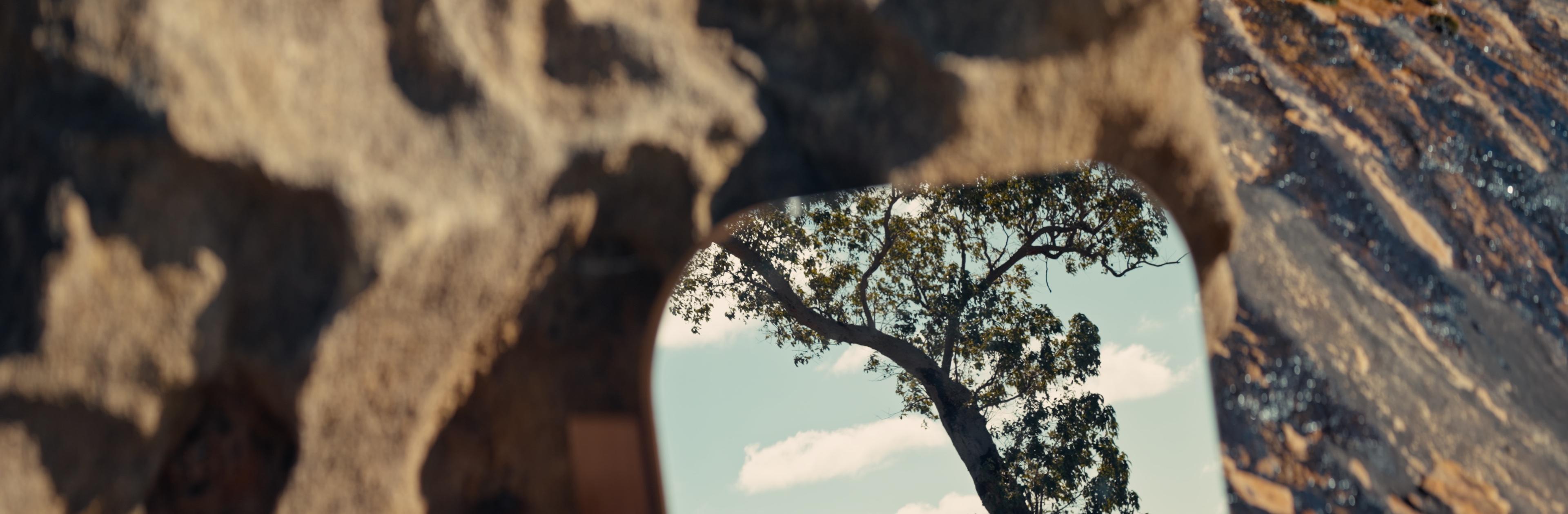 A mirror set in a granite arch reflecting a gum tree, from Jarrimber’s Provenance film