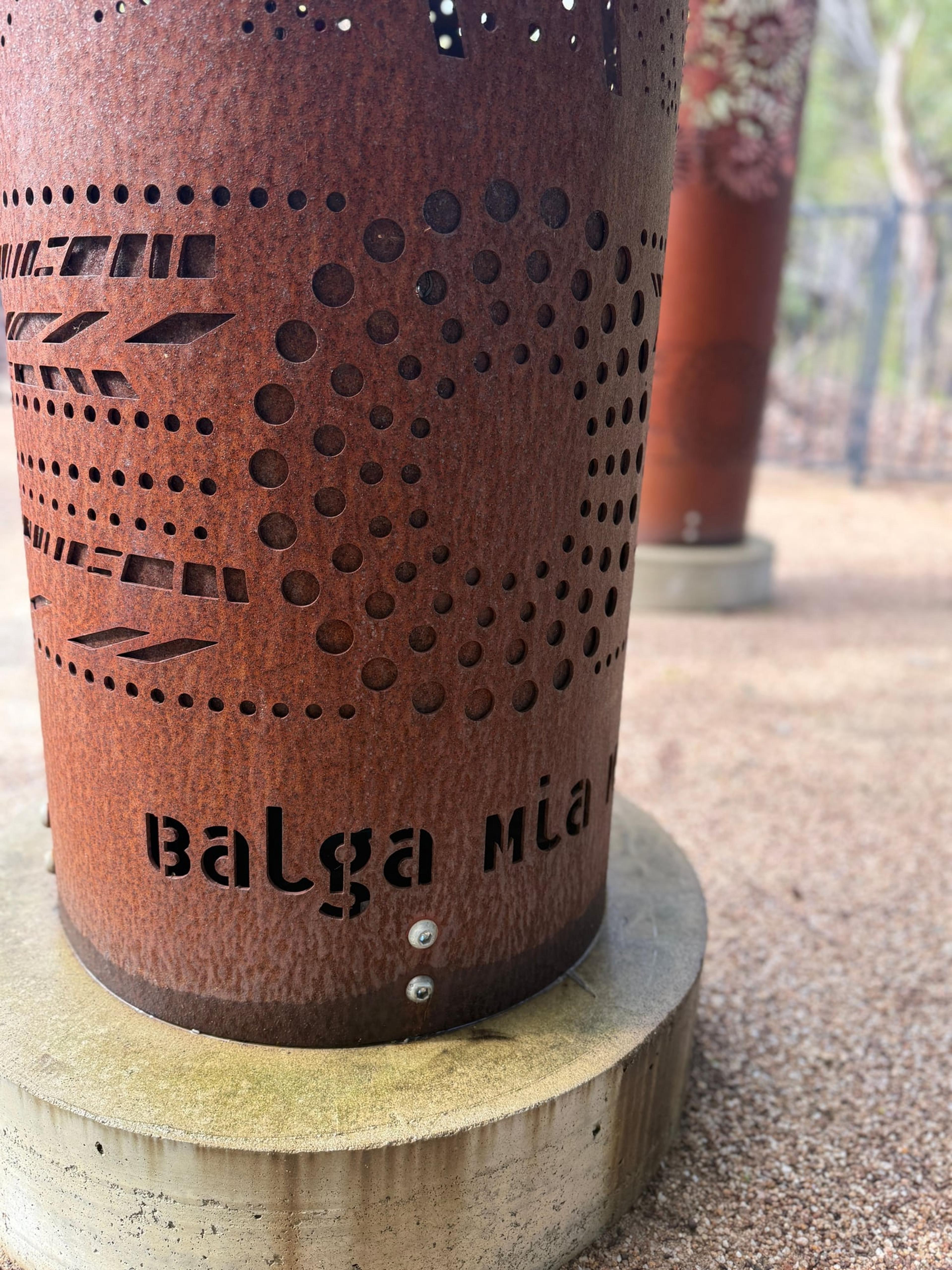The name Balga Mia Mia cut into rusted steel on a weathered concrete base