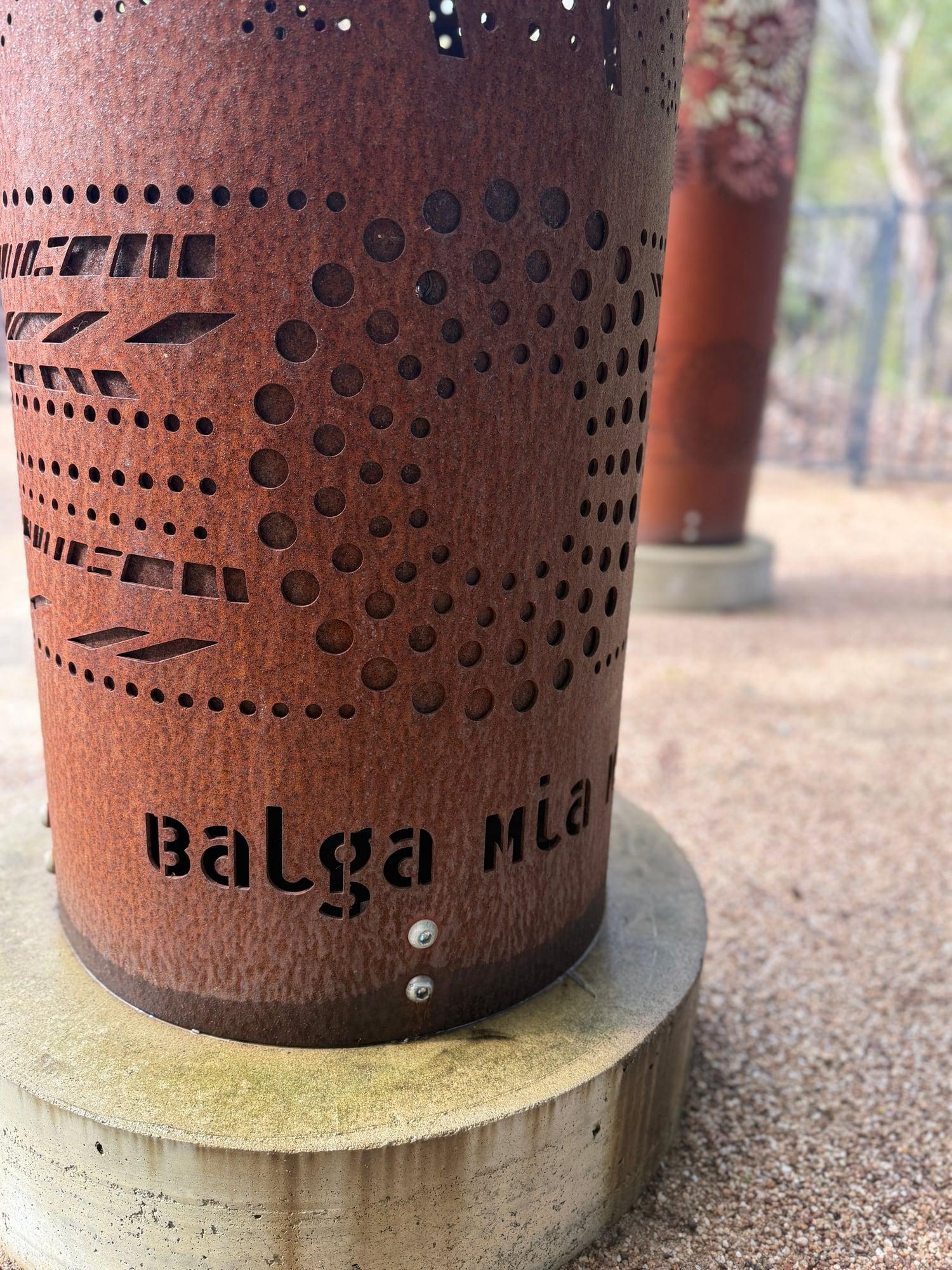 The name Balga Mia Mia cut into rusted steel on a weathered concrete base