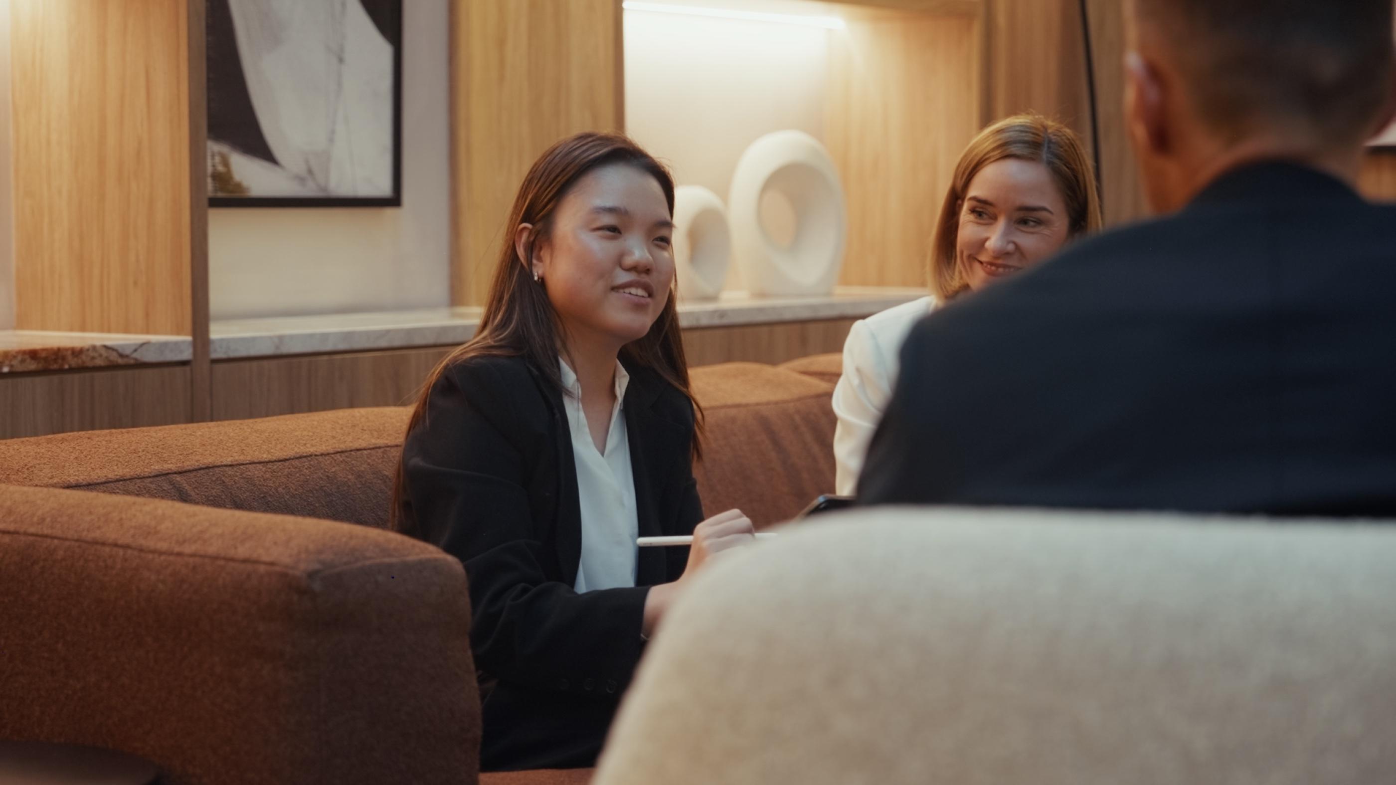 A lawyer smiling with clients in a lounge