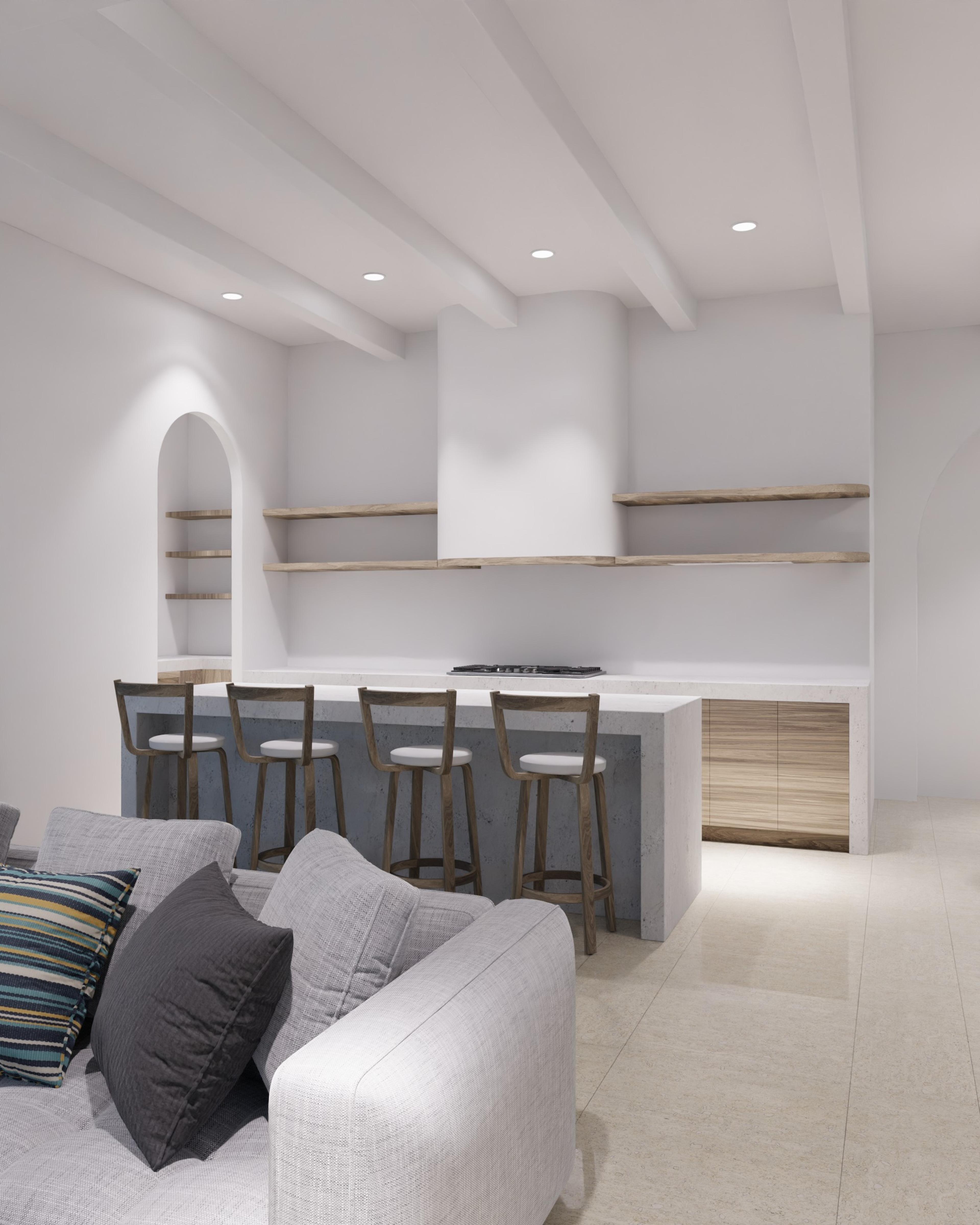 Kitchen island with bar stools beside an arched alcove