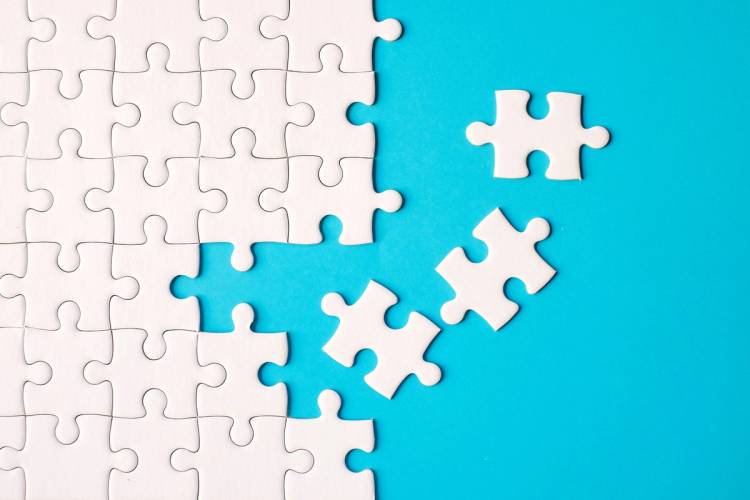 Jigsaw puzzle with all white pieces on a blue background