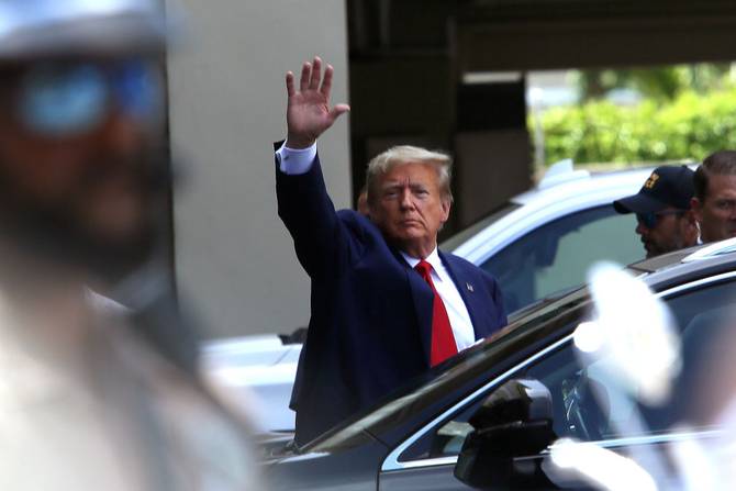  Former U.S. President Donald Trump waves as he makes a visit to the Cuban restaurant Versailles after he appeared for his arraignment on June 13, 2023 in Miami, Florida