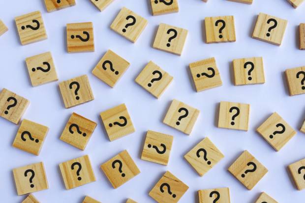 Question marks on wooden tiles