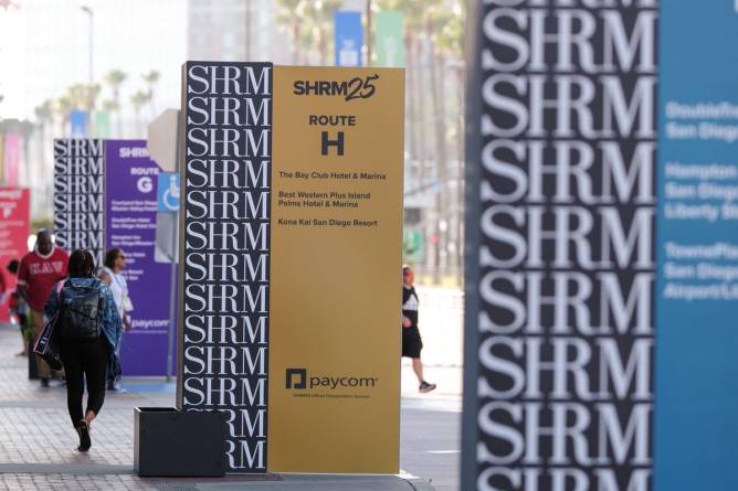 Attendees at SHRM's 2025 annual conference walk outside the San Diego Convention Center.