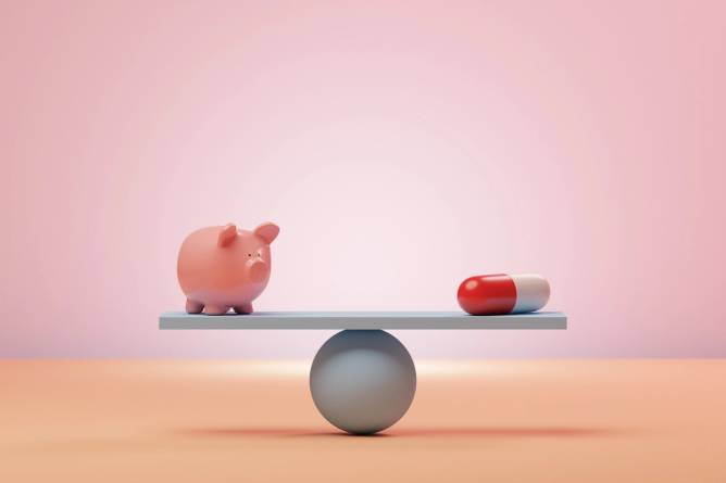 piggy bank and a pill on opposite ends of a scale