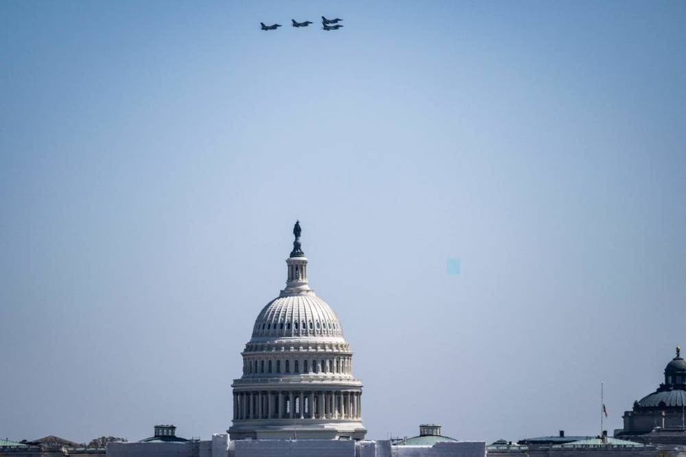 F-16 aircraft are seen above the US Capitol building after a flyby over Nationals Park stadium in Washington, DC on March 30, 2023