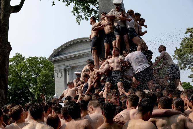 Freshmen known as "Plebes" participate in the annual Herndon Monument Climb at the U.S. Naval Academy on May 17, 2023