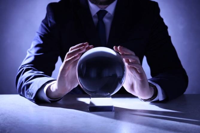 businessman holds a crystal ball