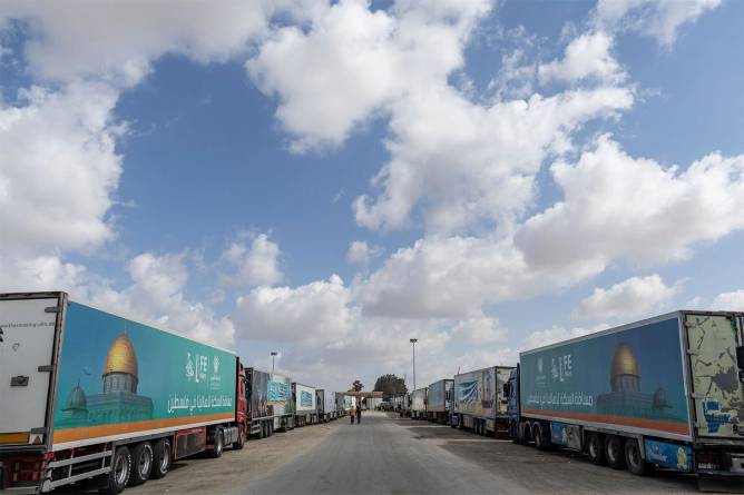 Aid trucks wait at the Rafah Crossing on the border of Gaza and Egypt