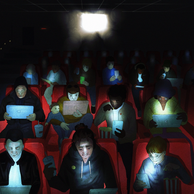 People looking at their phones while watching a movie