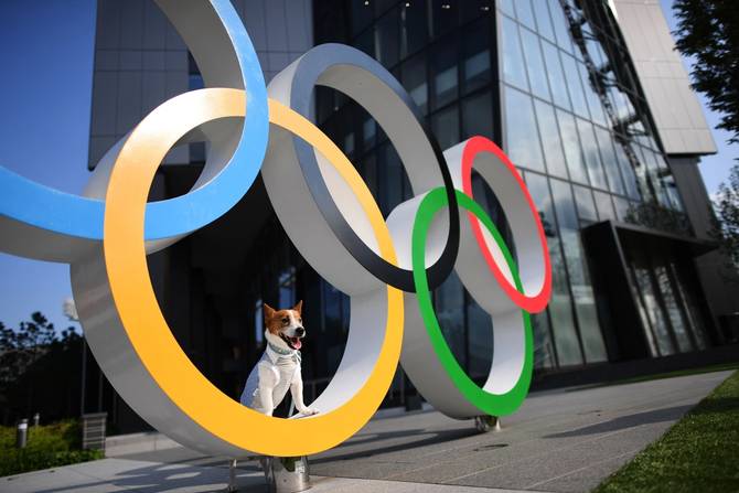 A dog is pictured on the Olympic Rings displayed at the Japan Sport Olym...