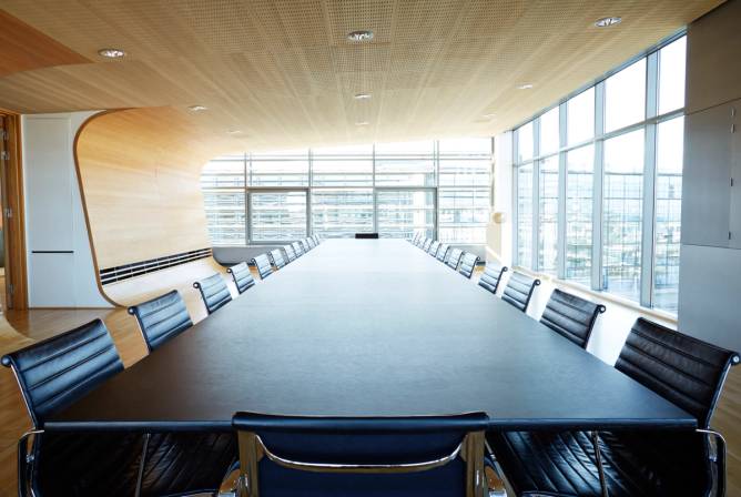 A view over a huge table in a boardroom