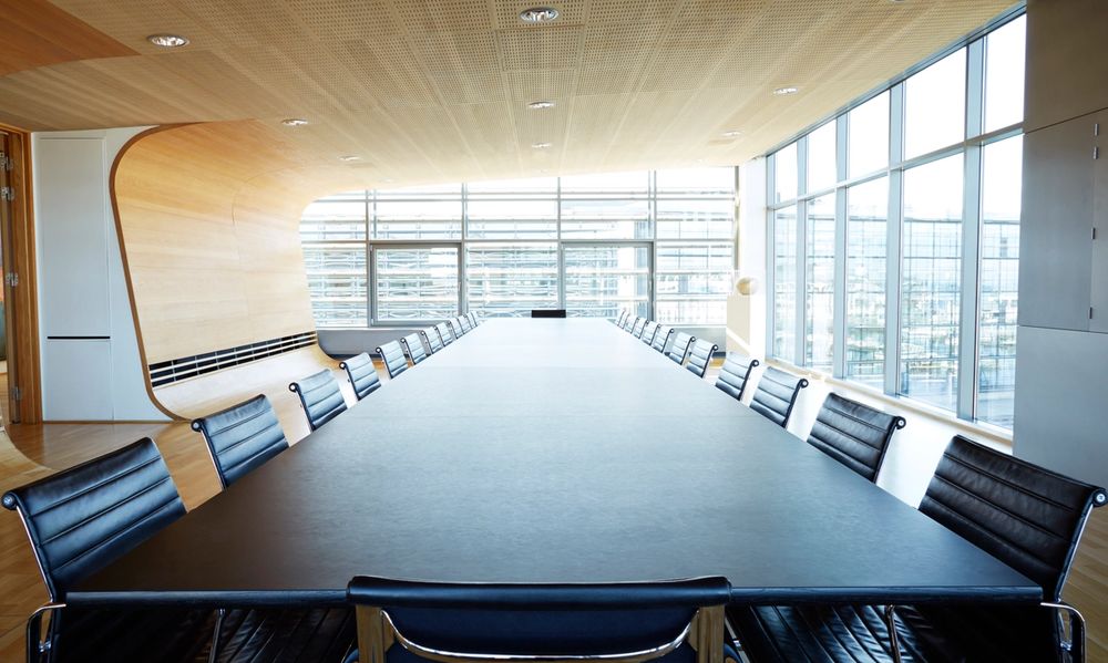 A view over a huge table in a boardroom