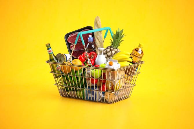 A shopping basket full of grocery store staples