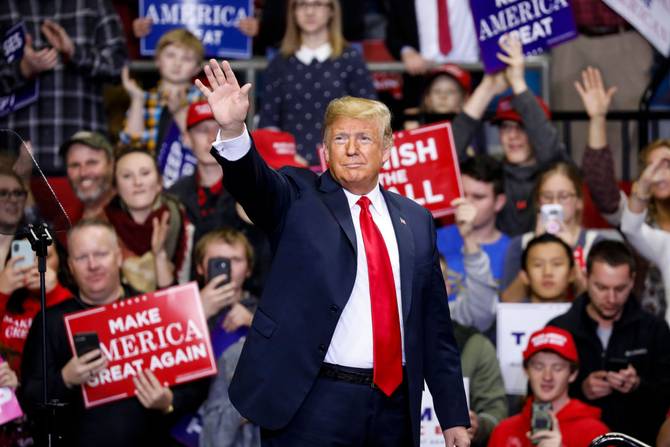 Former President Trump waving at a rally