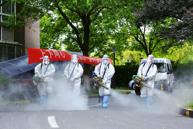 Members of the Blue Sky Rescue Team disinfect a residential community during the phased lockdown triggered by the COVID-19 outbreak.