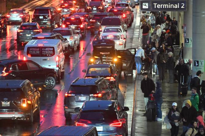 a busy curbside area at an airport