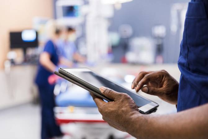 Person holding an iPad in a hospital