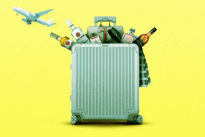 A suitcase overflowing with purchases from the airport