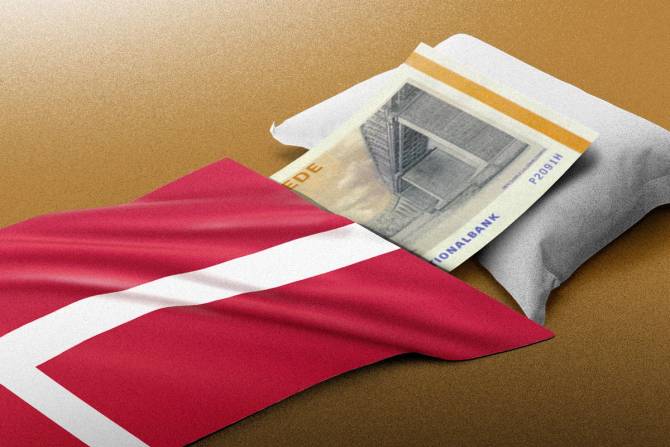 A Danish Kroner sleeping safely beneath the country's flag