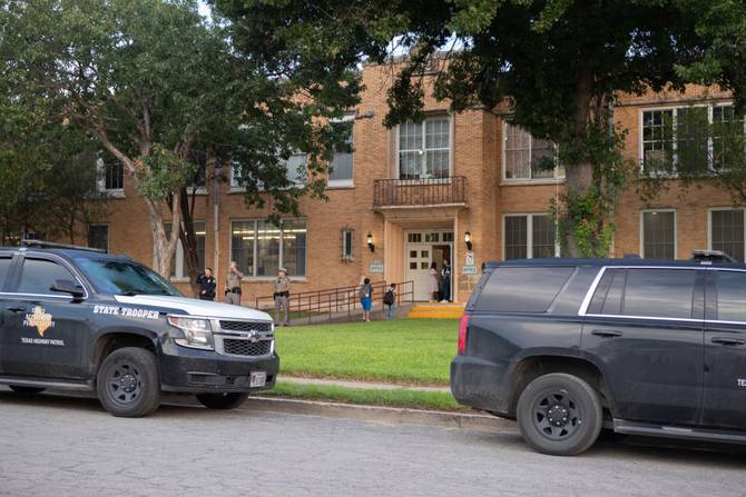 Police vehicles in front of a Uvalde school