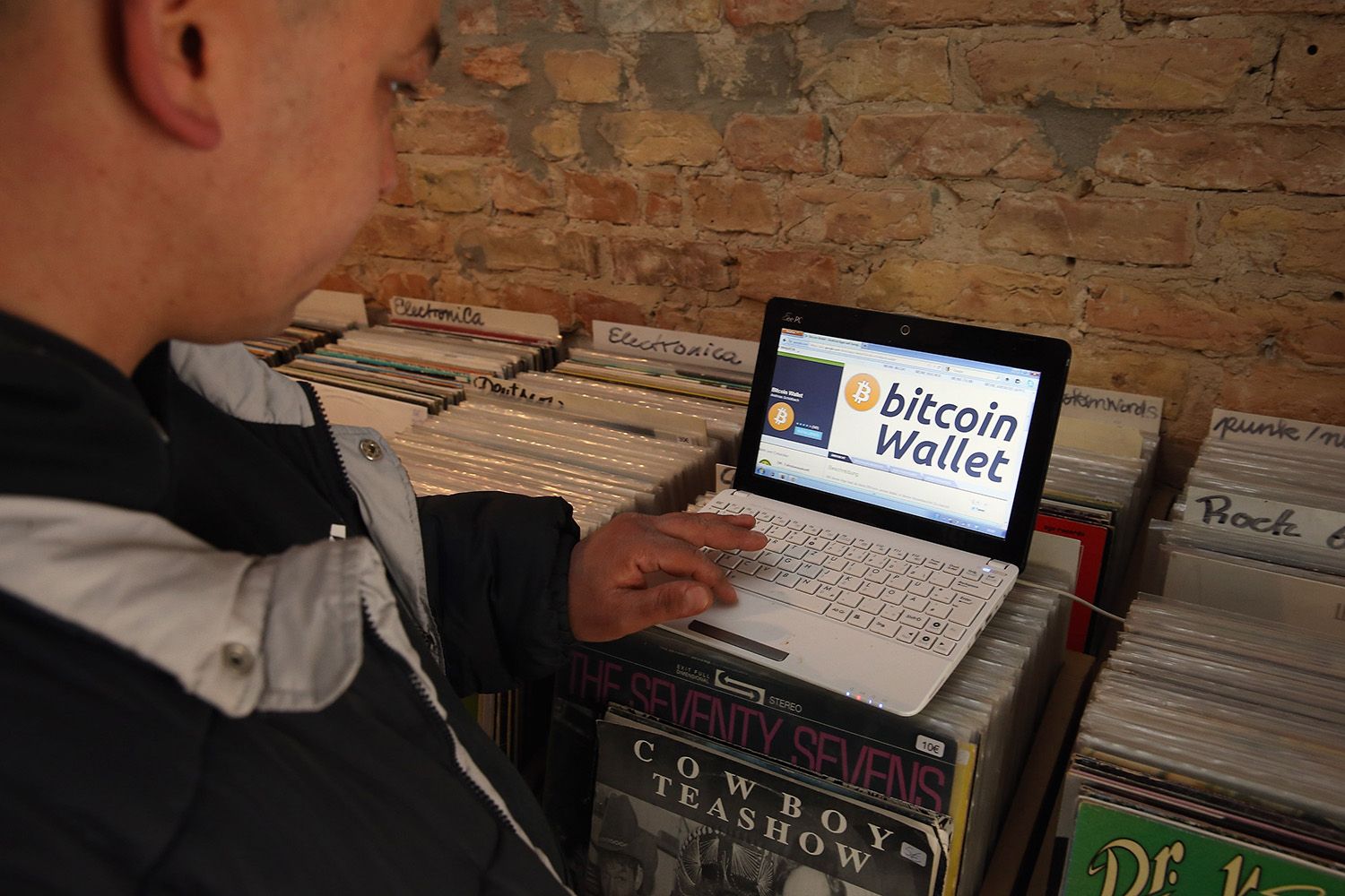 A man with an open laptop, website browser for bitcoin