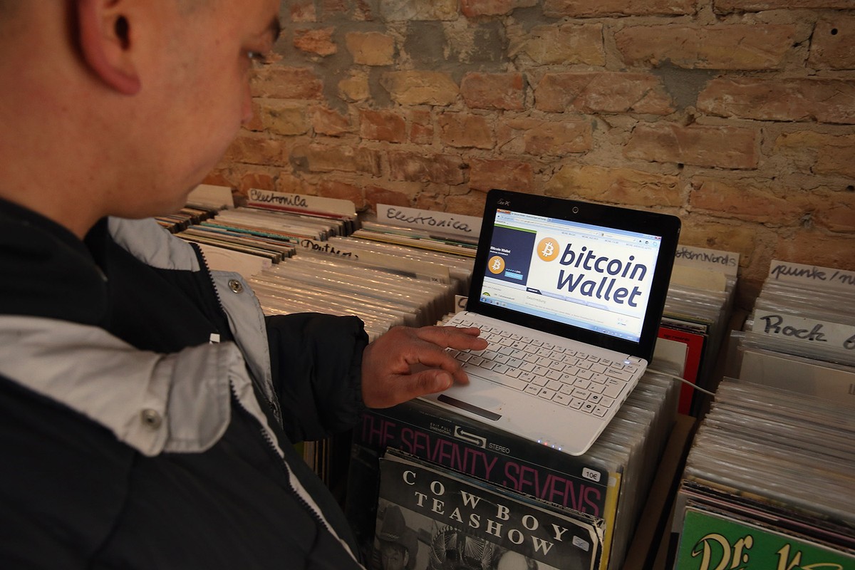 A man with an open laptop, website browser for bitcoin
