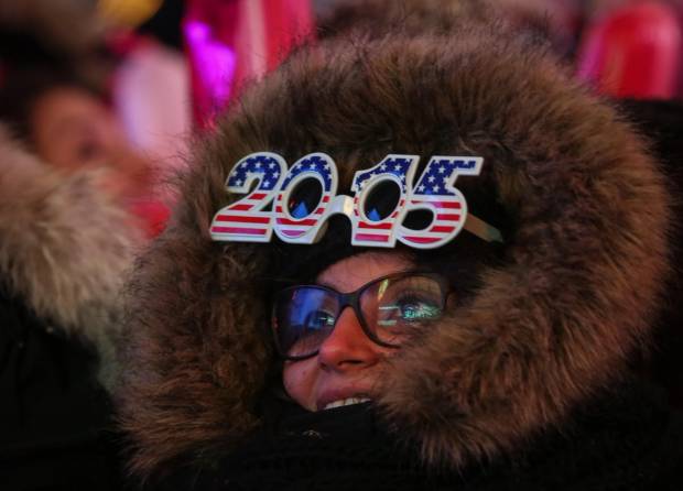 A reveler wearing 2015 glasses on New Year's Eve in New York's Times Square