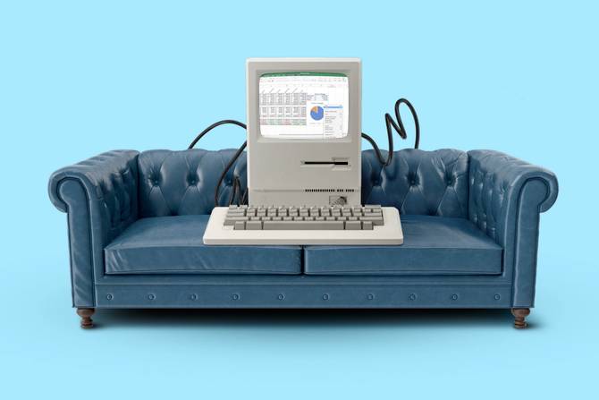 An illustration of an upholstered blue couch with an old computer and keyboard sitting on it. 