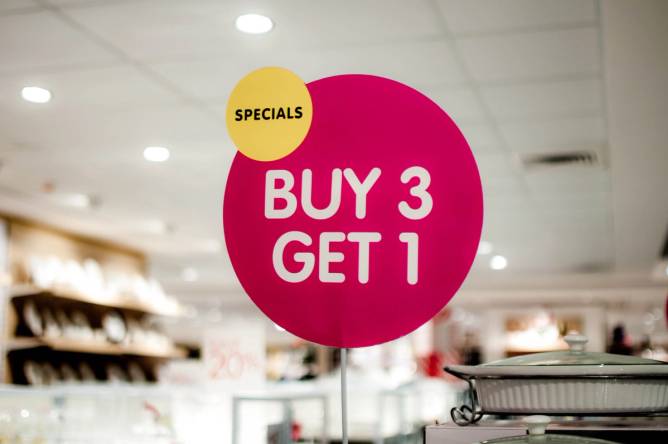 A "buy 3, get 1" sign on a shopping mall