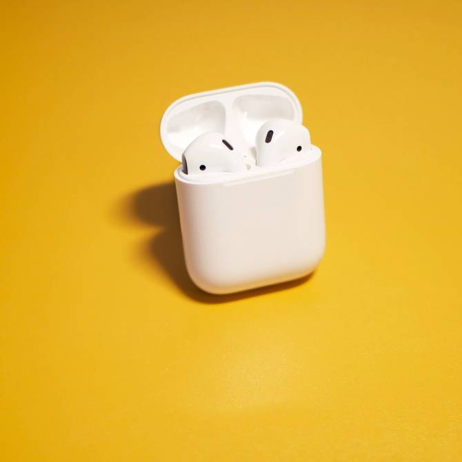 Airpods and case on a yellow background