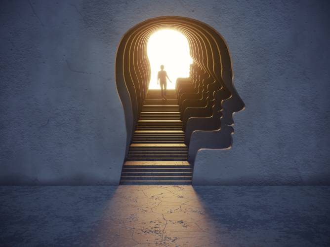 robot head shaped stairwell with person climbing the steps