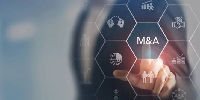 A finger pointing at a screen with M&A displayed on it.
