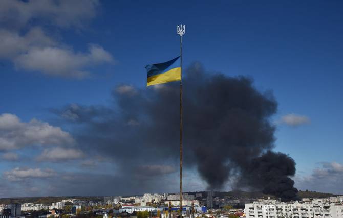 Smoke rising from a bombing in a Ukrainian city with the Ukrainian flag in the foreground