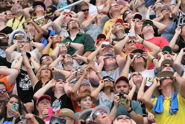 People watch the solar eclipse at Saluki Stadium on the campus of Southern Illinois University on August 21, 2017 in Carbondale, Illinois