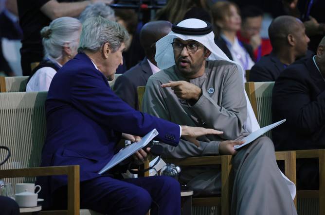 John Kerry (L), U.S. special presidential envoy for climate, and Sultan Ahmed Al Jaber, President of the COP28 UNFCCC Climate Conference, speak with one another