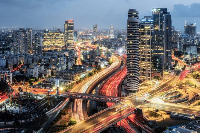 A long-exposure photograph of a Tel Aviv skyline