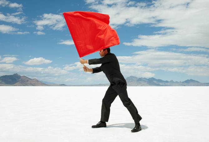 business man waving red flag